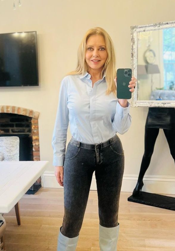 Carol Vorderman in blue skirt and skinny jeans