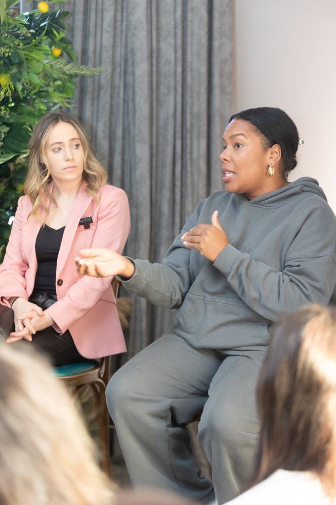 Woman in grey tracksuit gesturing as she talks