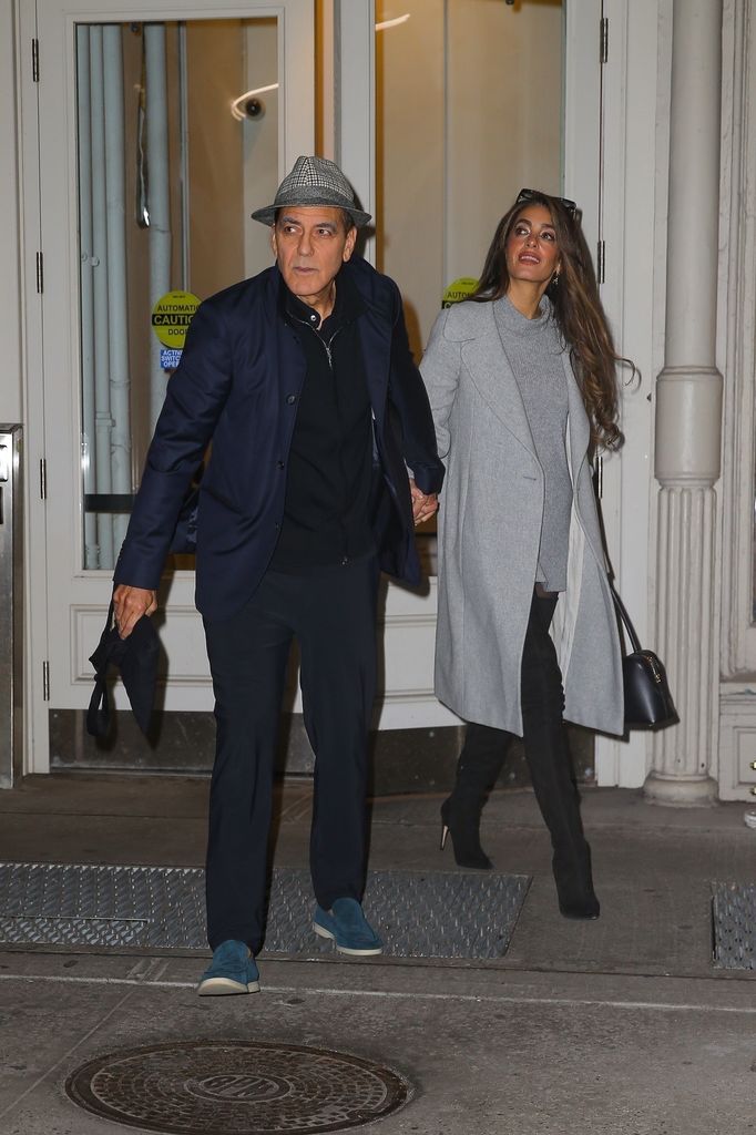  George Clooney and his wife Amal Clooney hold hands as they head out together in New York.