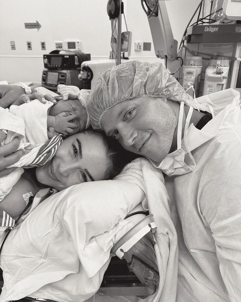 Olivia Culpo and Christian McCaffrey hold their newborn baby girl in a photo captured after labor at the hospital, shared on Instagram