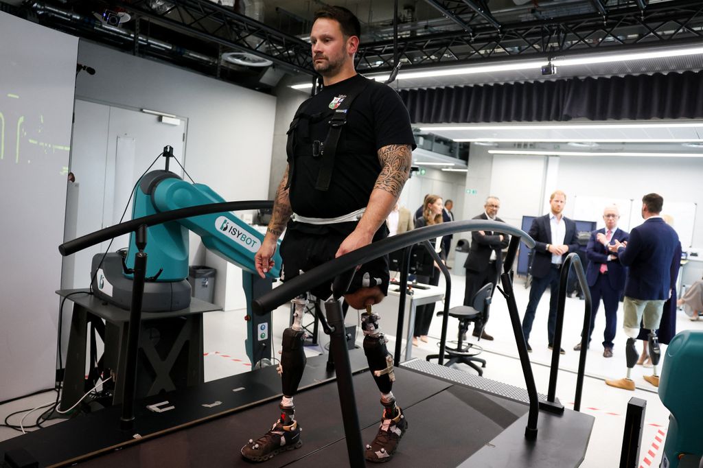 Harry looks on  as Steve Arnold demonstrates the gait work lab