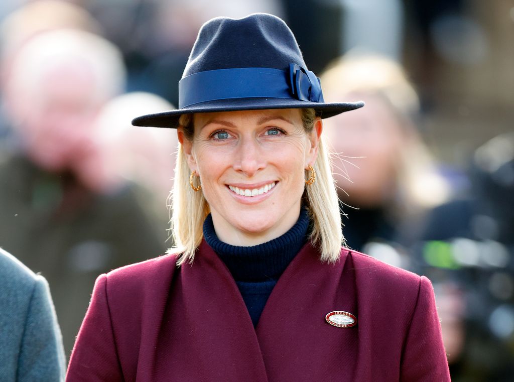 Zara Tindall in burgundy coat and blue hat