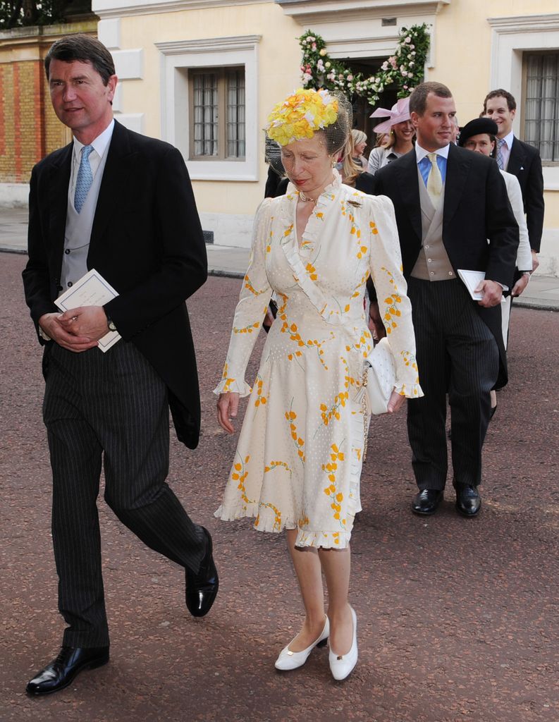 The Princess Royal in a white wedding guest dress with her husband Timothy Laurence