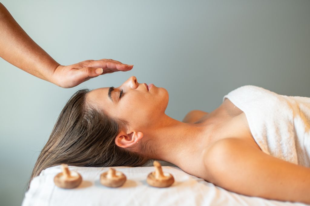 Woman lying next to three mushrooms 