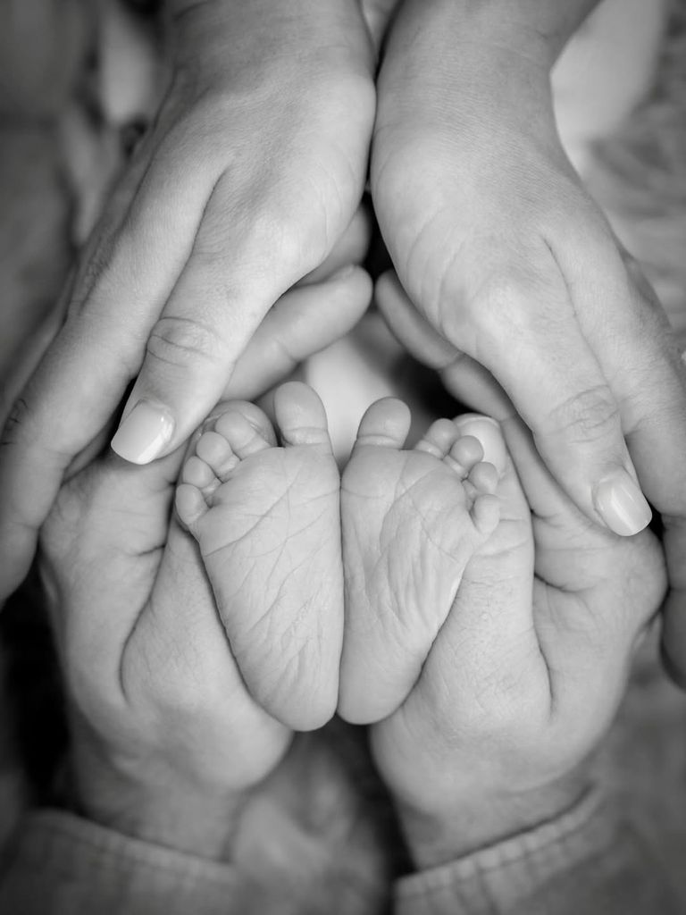 Derek Hough and Hayley Erbert cradle the feet of their newborn baby daughter Everley, shared on Instagram