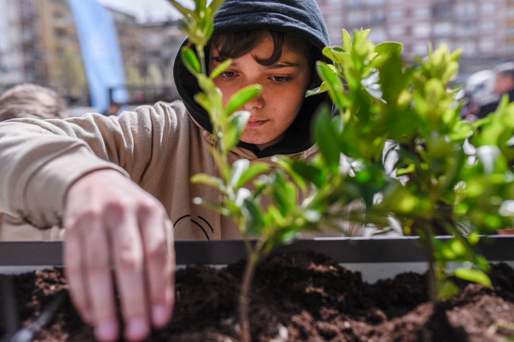 a student taking part in a planting competition 