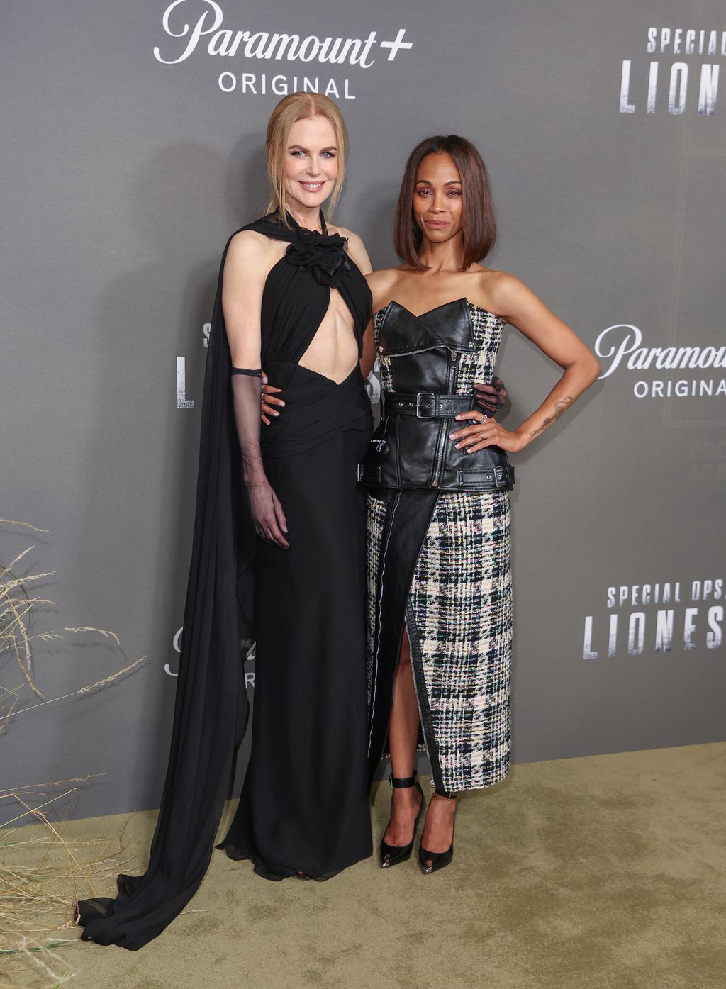 Nicole Kidman in black cut out dress posing with Zoe Saldana at Special Ops: Lioness
