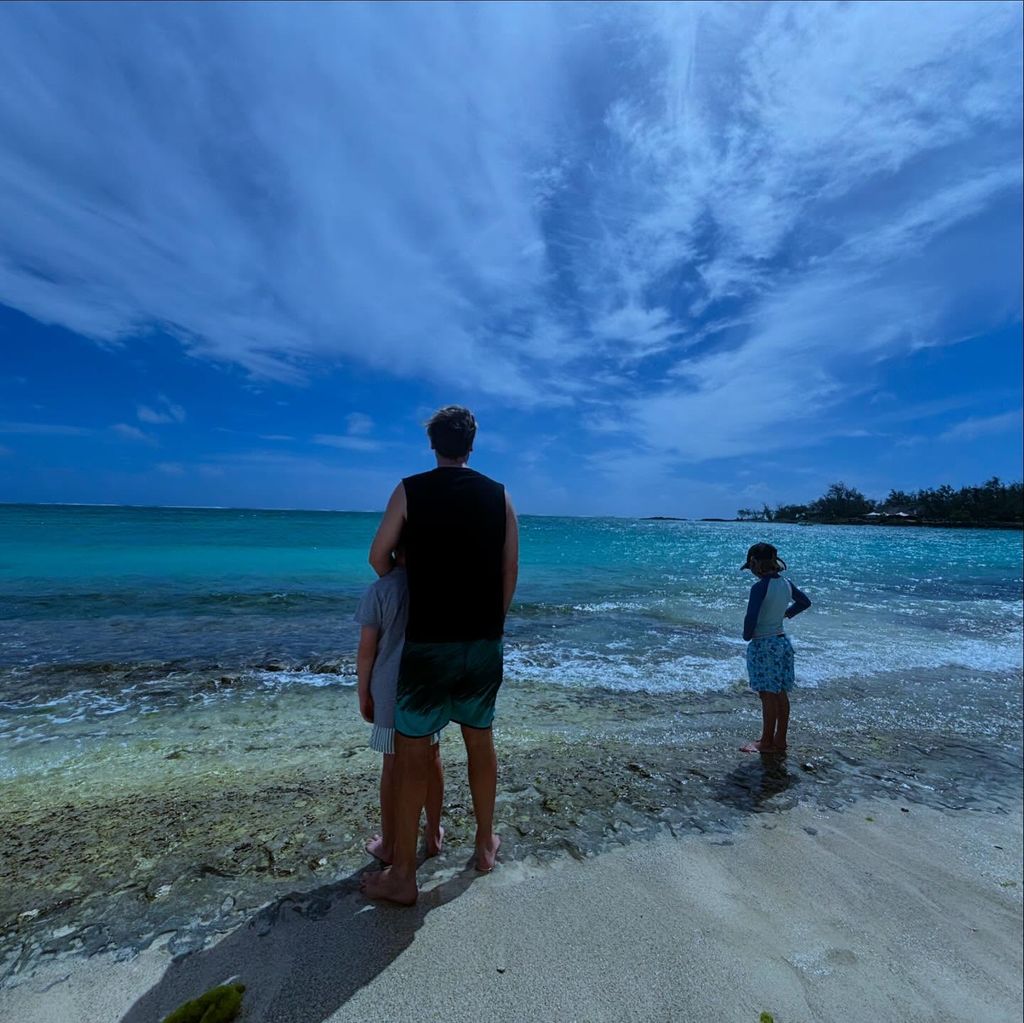 man on the beach with his two sons 