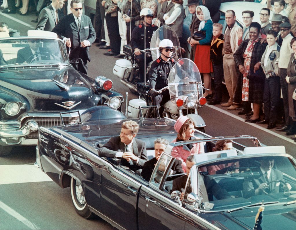 US President John F Kennedy, First Lady Jacqueline Kennedy, Texas Governor John Connally, and others smile at the crowds lining their motorcade route in Dallas, Texas, on November 22, 1963. Minutes later the President was assassinated as his car passed through Dealey Plaza.