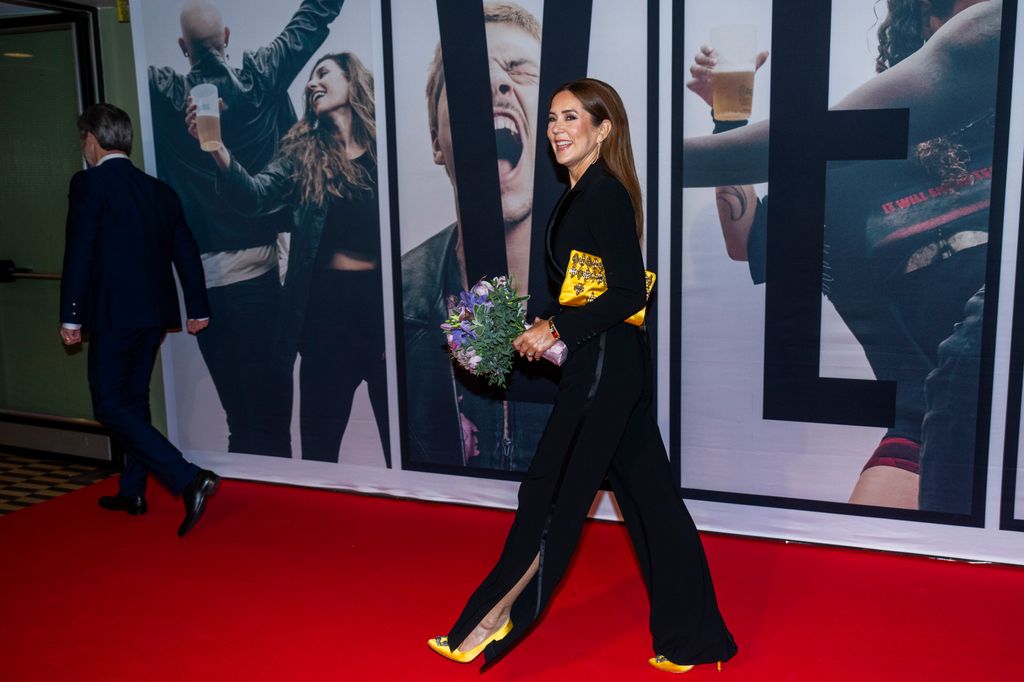 Queen Mary on the red carpet with yellow accessories 