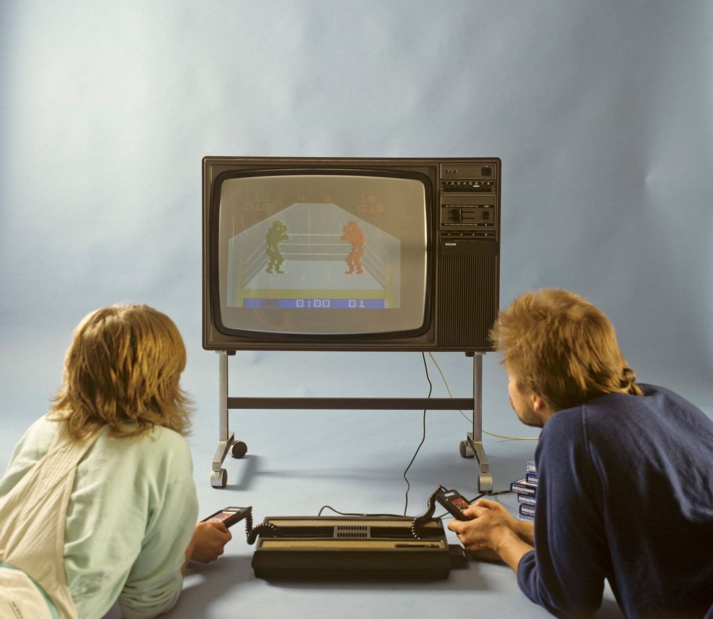 Home video games in the 1980s. A home video game console from Intellivison released by Mattel electronics in 1979. Pictured two people playing a boxing game on a television set. (Photo by SjÃ¶berg BildbyrÃ¥/ullstein bild via Getty Images)