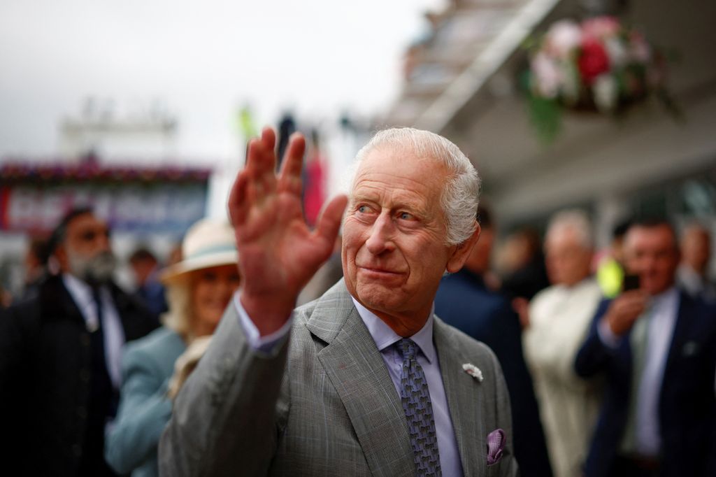 King Charles waving at members of the public