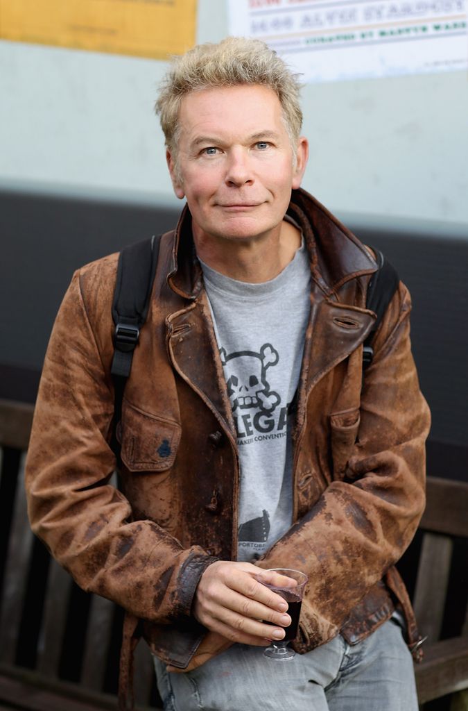 Julien Temple in a brown jacket and grey shirt