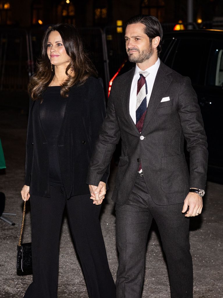 Princess Sofia in an all-black ensemble walking with carl philip