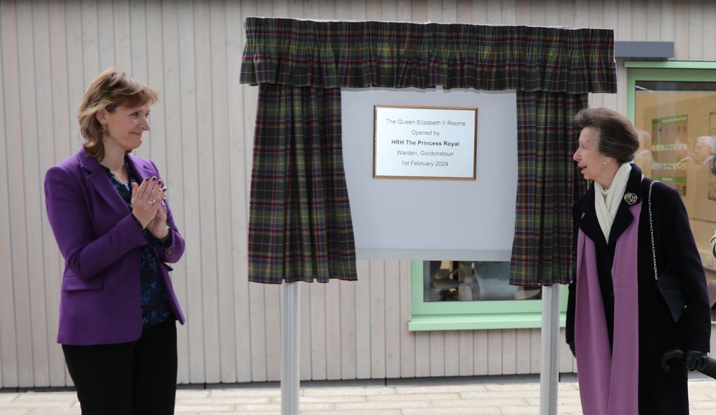 Princess Anne standing next to a plaque for a classroom at Gordonstoun