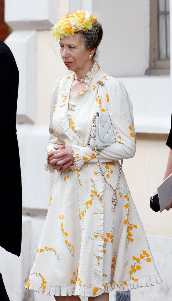 Princess Anne in a white ruffled dress and yellow headpiece
