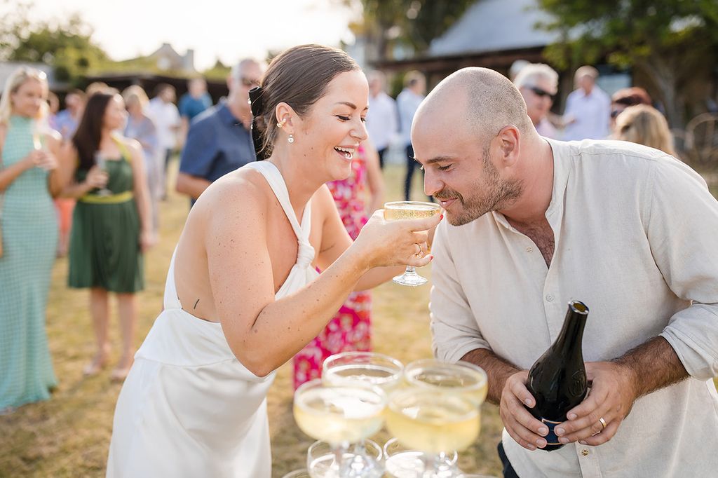 Man and woman drinking outside at wedding
