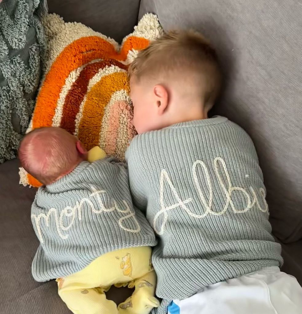 two brothers snuggling on sofa 