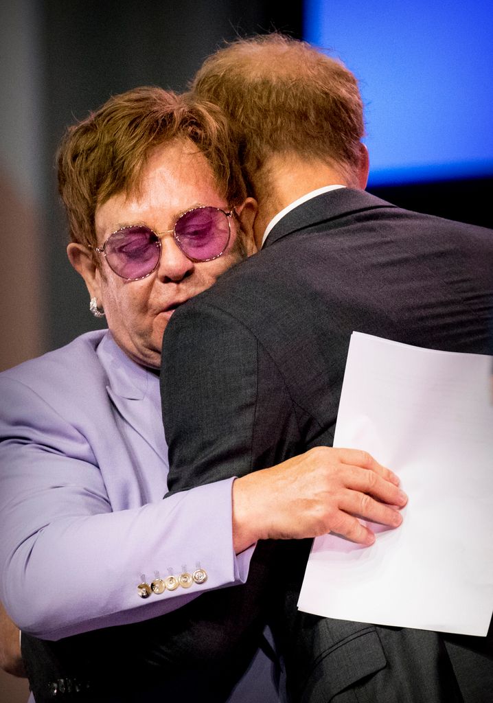 Sir Elton John and Prince Harry, Duke of Sussex embrace during the 2018 International AIDS Conference 