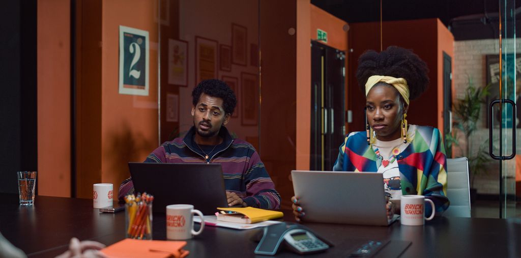 two people on laptops at desk
