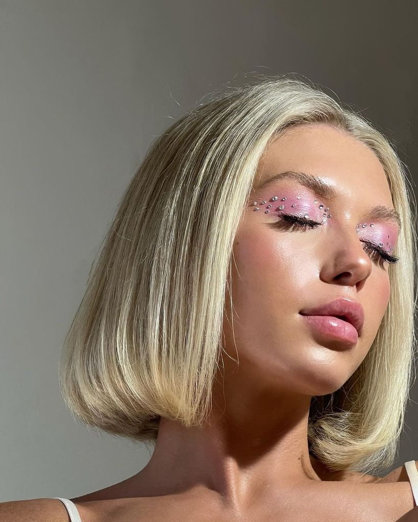 Woman with pink eyeshadow and glittery studs 