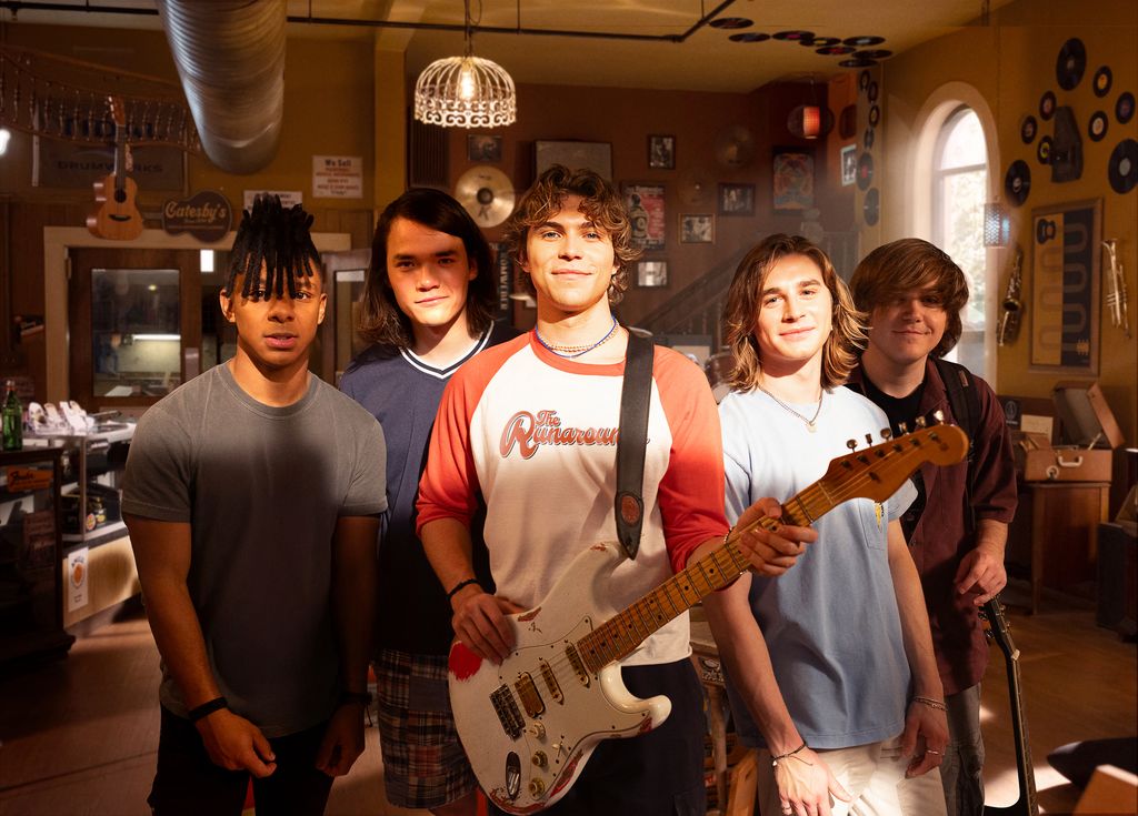 group of teen boys, one holding guitar