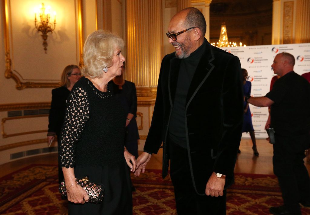 Bruce Oldfield is greeted by Camilla, Duchess of Cornwall during  the Bruce Oldfield Fashion Show at Lancaster House in support of the NationLONDON, ENGLAND - NOVEMBER 15: al Osteoporosis Society on November 15, 2017 in London, United Kingdom. (Photo by J