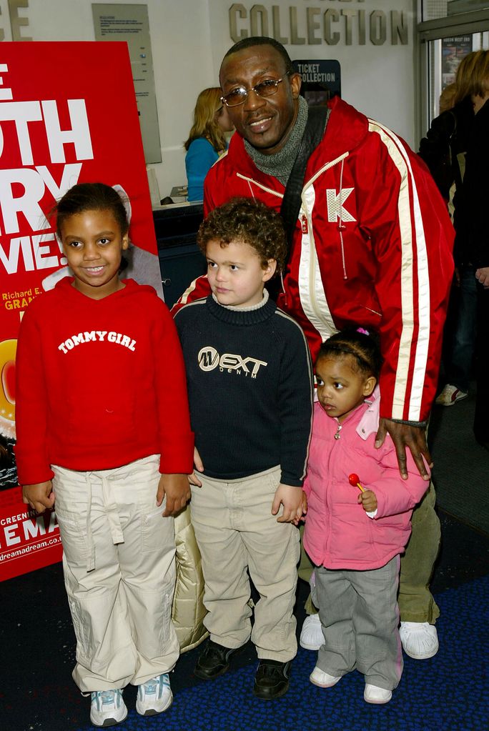 Linford Christie with three young children