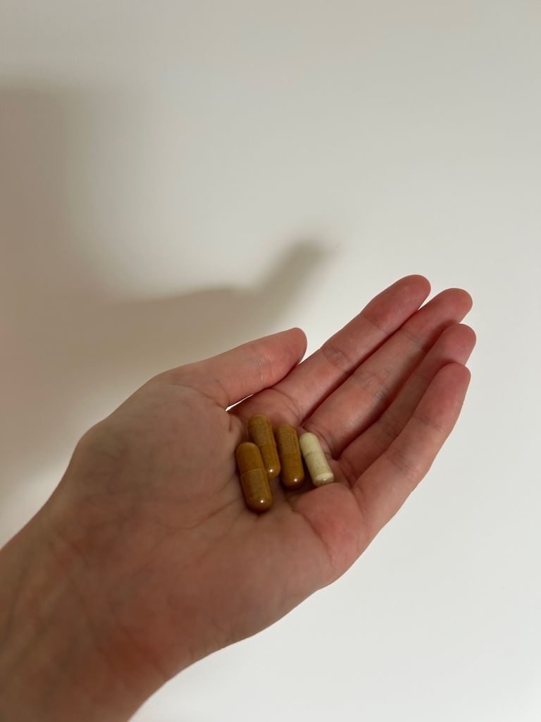 A hand holding supplements