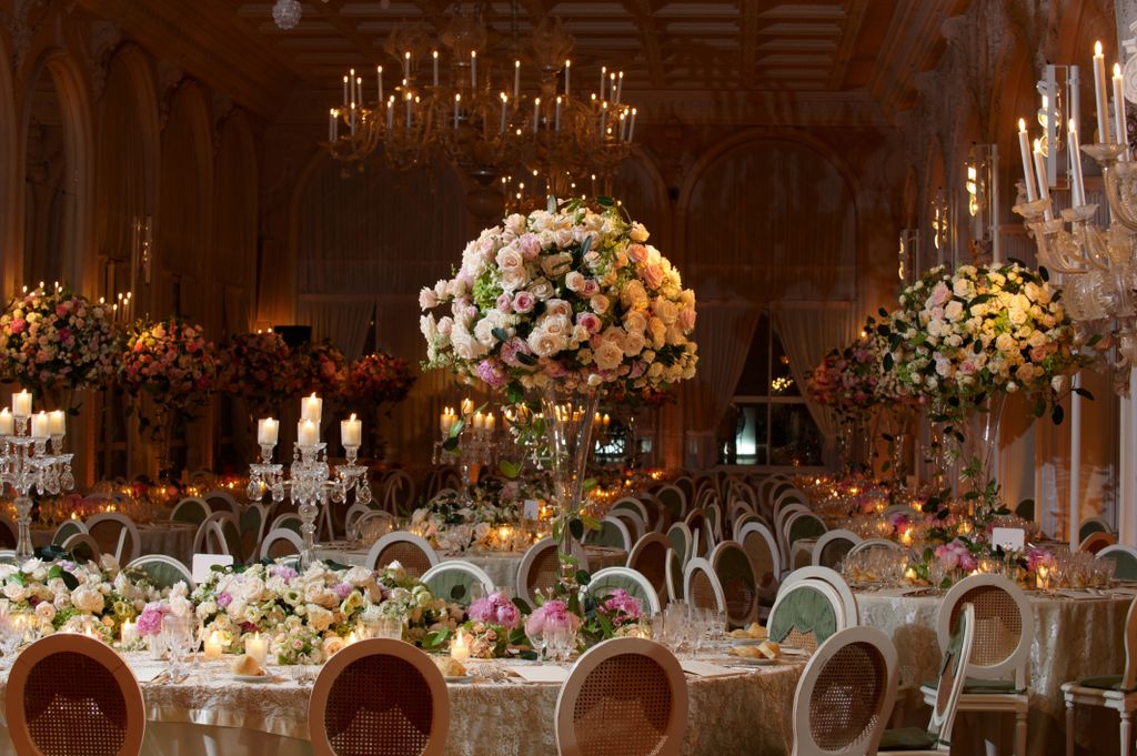 A large wedding reception room with beautiful flower displays