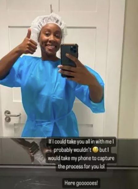 Scarlette Douglas giving a thumbs up in a blue hospital gown