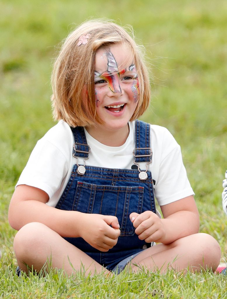 Mia Tindall wearing face paint and dungarees
