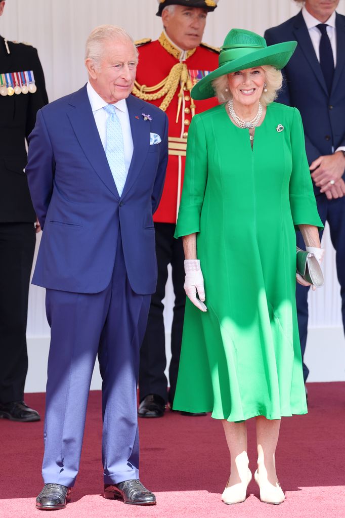 King Charles standing with Queen Camilla