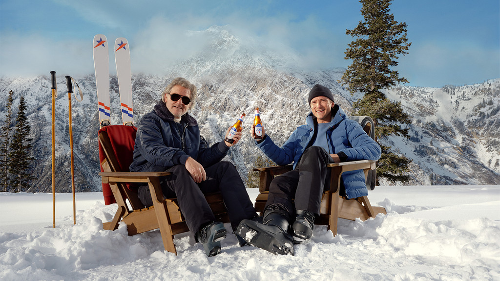 Kurt Russell and Lewis Pullman pose for a promotional image for Michelob ULTRA's Super Bowl LX commercial