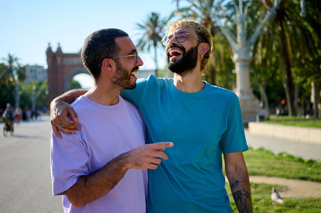 Happy lgbtqia+ couple enjoying vacation in Arc de Triomf. Barcelona, Spain