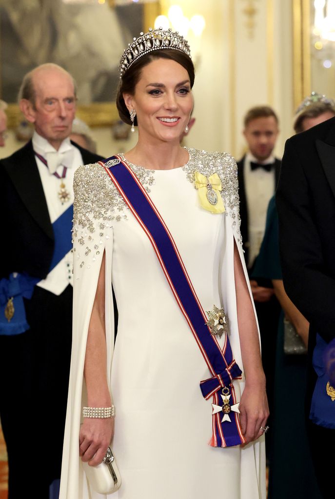 Catherine, Princess of Wales wearing the a white gown and the Queen Mary Lover's Knot Tiara