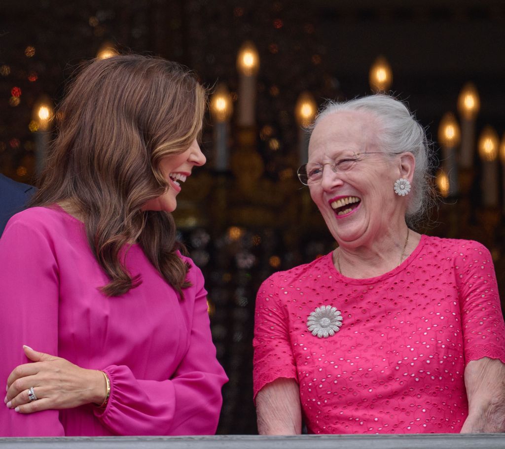 Queen Mary and Queen Margrethe laughing on the balcony