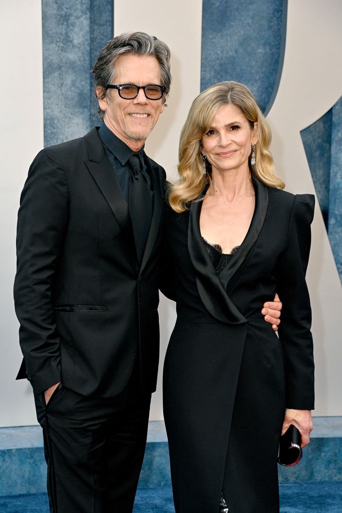Kevin Bacon and Kyra Sedgwick smiling on a red carpet