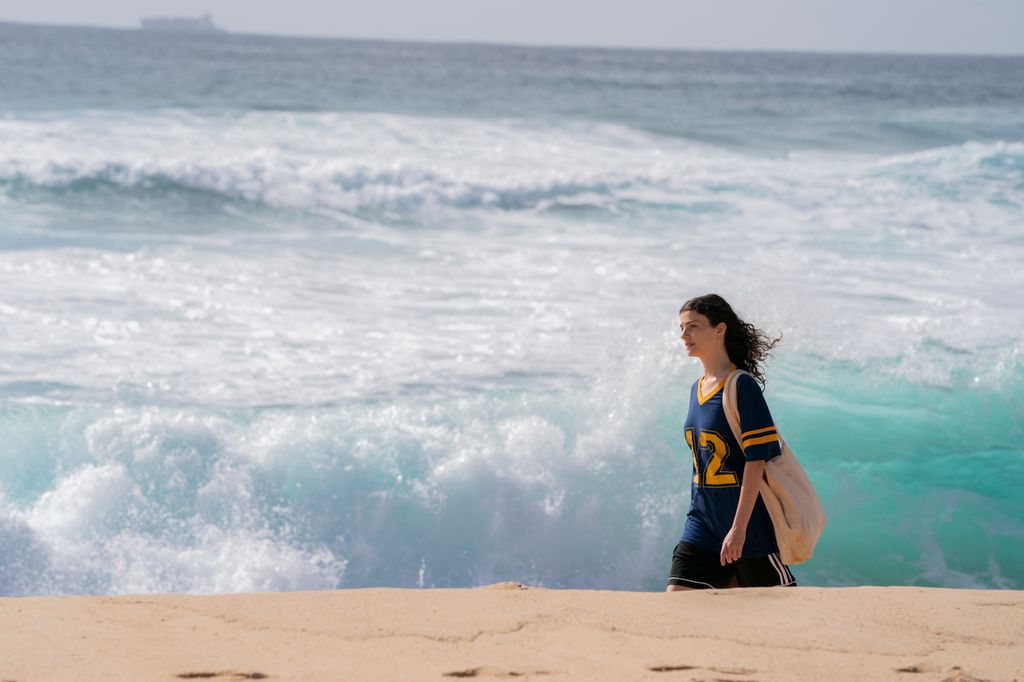 teenage girl walking on beach