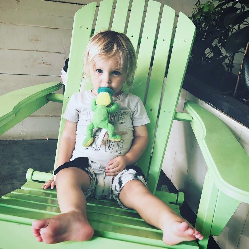 little boy on mint green deck chair