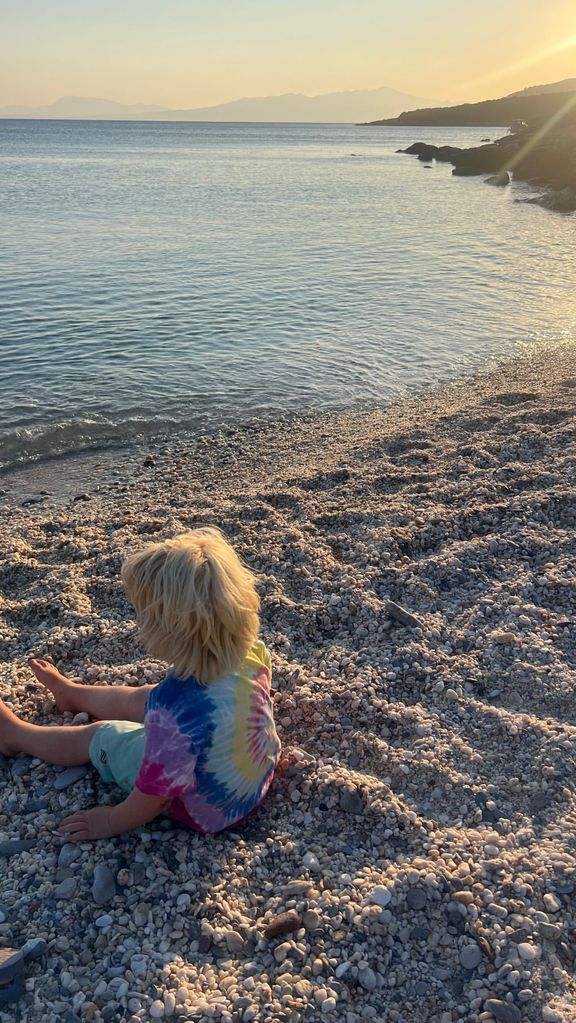 Carrie Johnson's son Wilf sitting on the beach