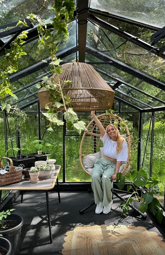Stacey Solomon sitting in egg chair after greenhouse transformation