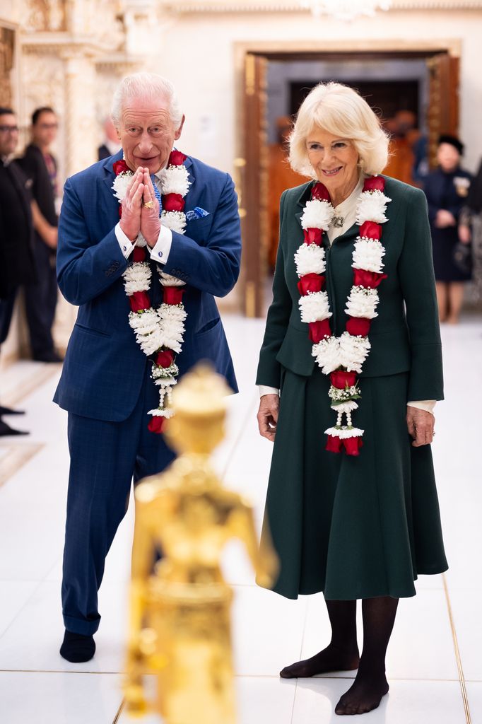 LONDON, ENGLAND - OCTOBER 29: King Charles III and Queen Camilla witness the Abhisheka process, a sacred Hindu bathing ritual, during a visit to BAPS Shri Swaminarayan Mandir (known as the 'Neasden Temple') on October 29, in Neasden, London. The royal couple observed spiritual ceremonies, met representatives from community and social impact initiatives the temple works with, before meeting members of the congregation. (Photo Aaron Chown - WPA Pool/Getty Images)