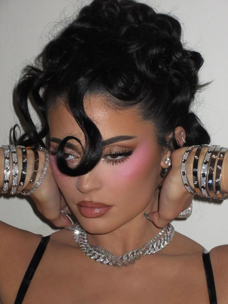 Kylie Jenner poses in a cut-out latex mini dress