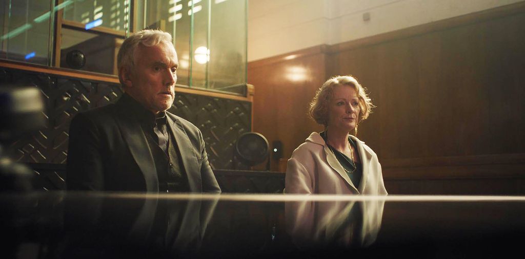 man and woman sitting at desk