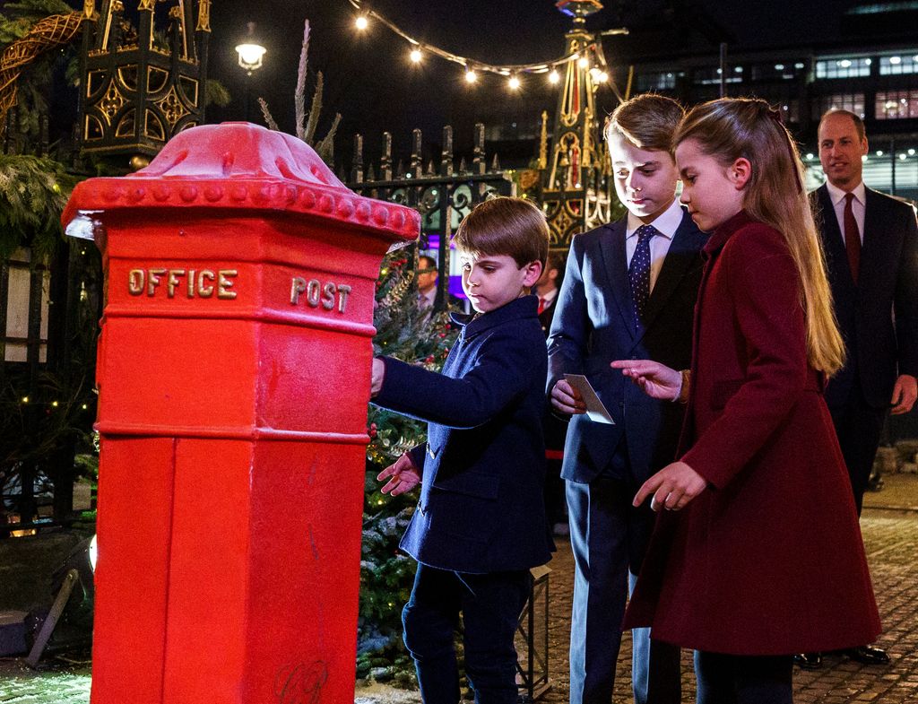 Prince Louis, Prince George and Princess Charlotte post letters at the Royal Carols concert