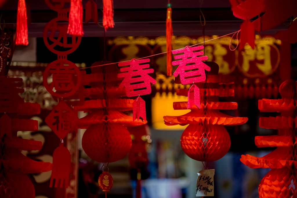 Red spring design hanging decoration and paper lantern for sale in Chinese New Year bazaar in Singapore Chinatown. Product are made of red paper and usually hang in houses or office as decoration to usher the Chinese Lunar New Year