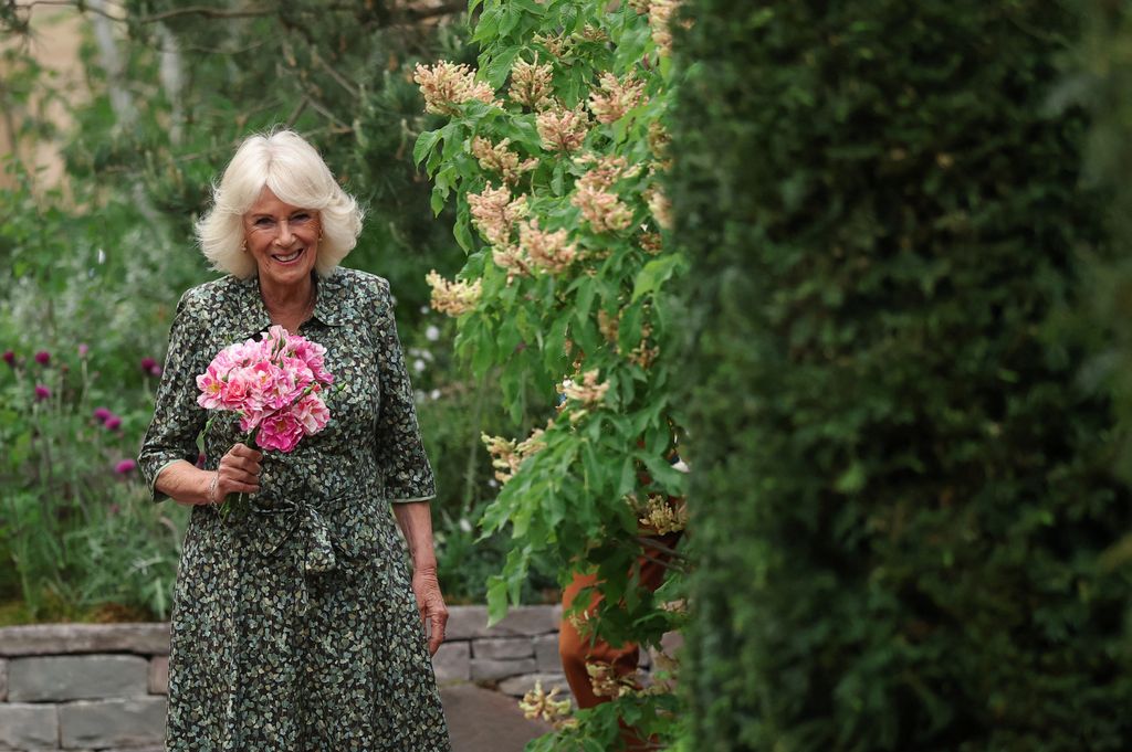 queen camilla holding bunch of roses