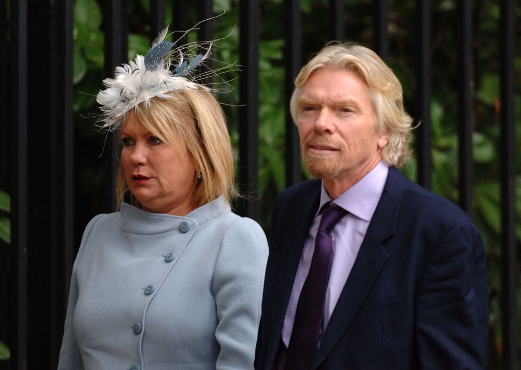 Joan Branson in a blue coat and fascinator and Richard Branson in a suit