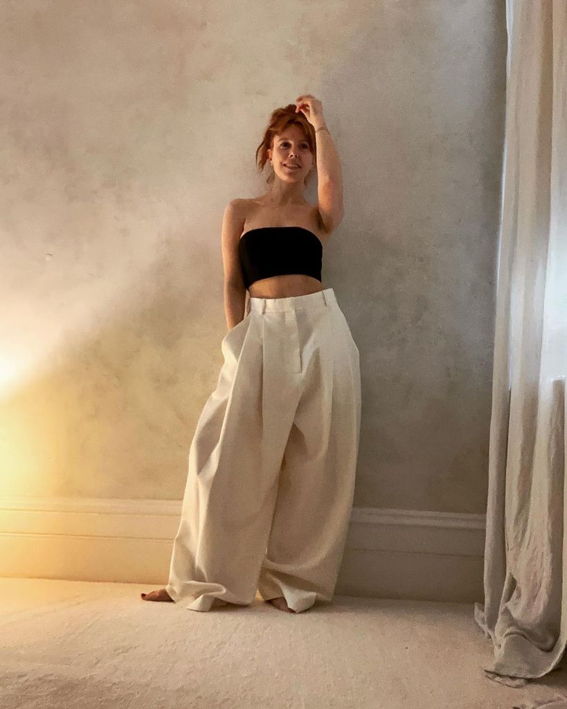 stacey dooley in cream flares and black bandeau top 